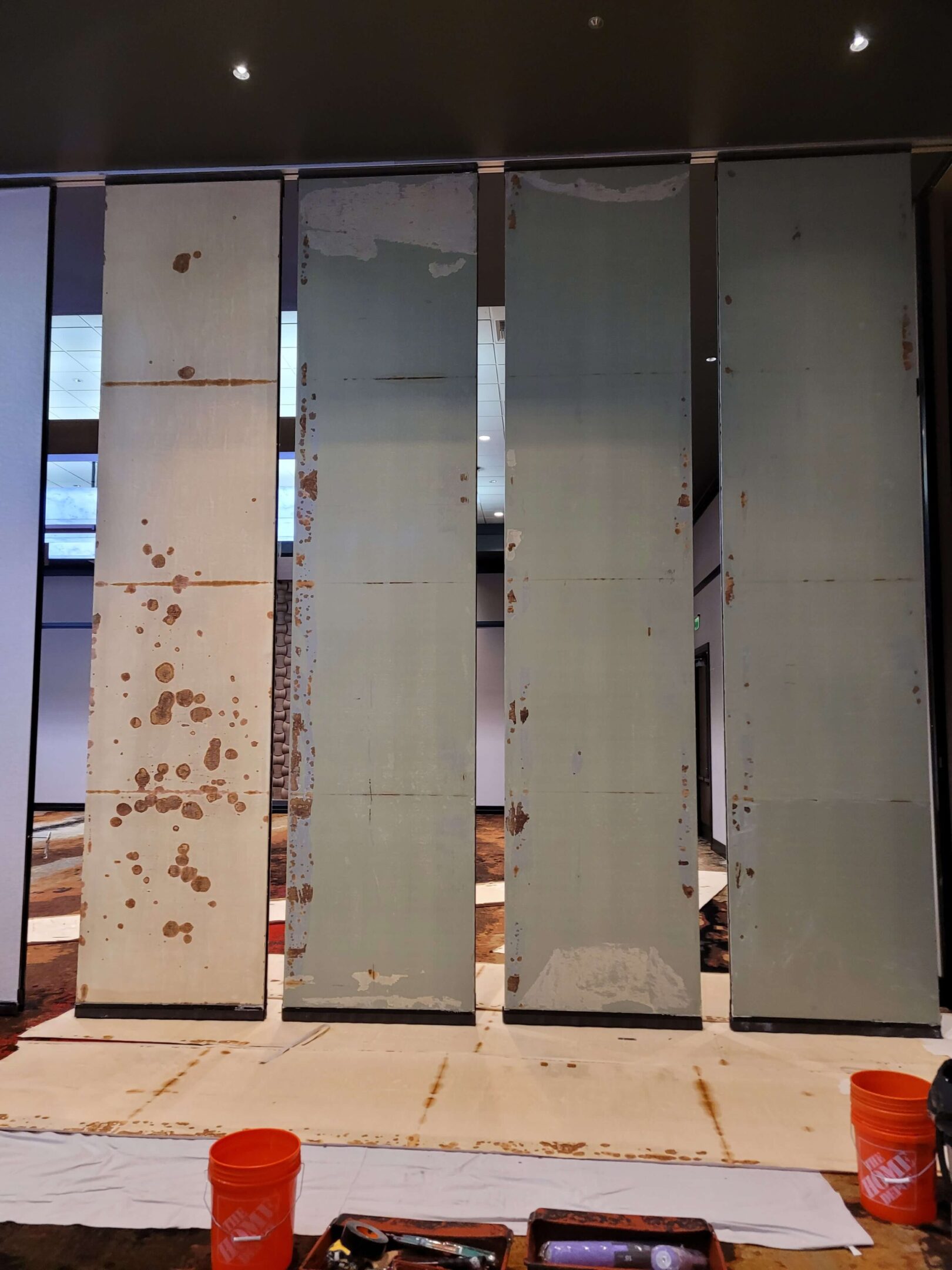 Hufcor operable partition panels undergoing rust abatement and preparation for recovery at W Austin.